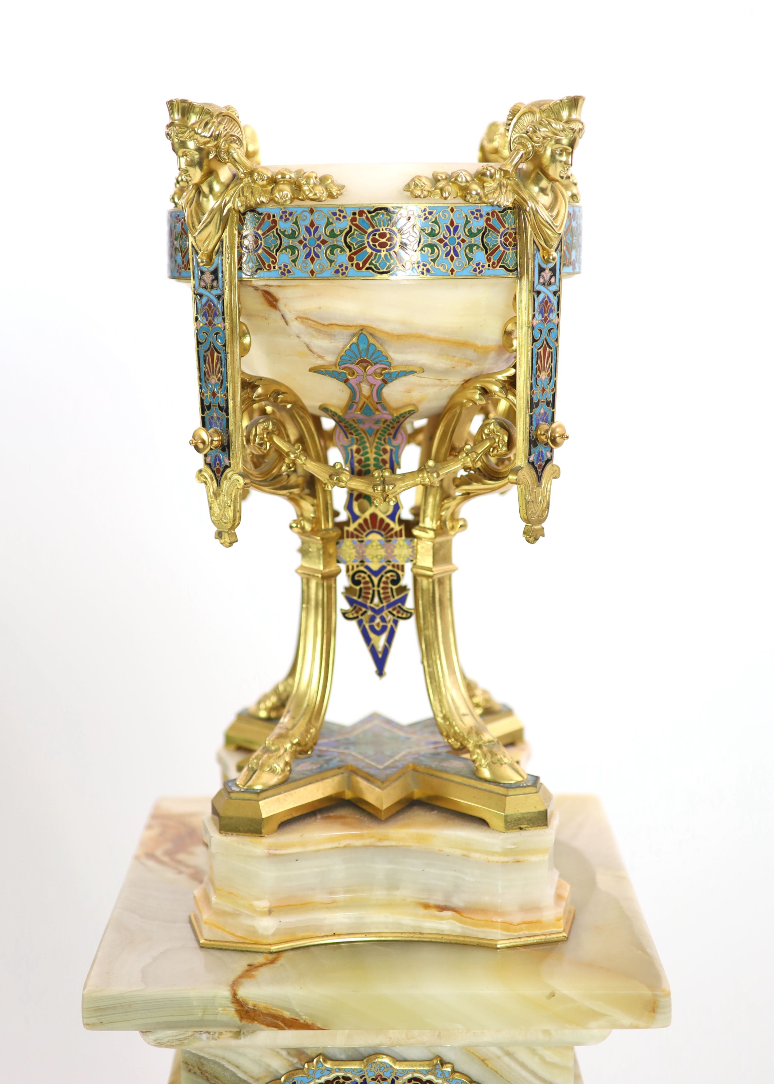 A pale cream onyx, gilt bronze and champlevé enamelled pedestal urn on swept supports with swag and satyr mask decoration and a similar onyx, gilt bronze and champlevé enamelled torchere Urn H 41cm. W 22cm. Pedestal H 10